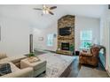 Bright living room featuring a stone fireplace and hardwood floors at 4072 Mackenzie Dr, Haw River, NC 27258