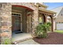 Inviting front porch with stone and brick accents, providing a warm entrance to the home at 4116 Argyle Trl, Burlington, NC 27215