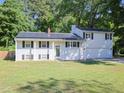 Charming two-story home with an attached garage, solar panels, and a well-maintained lawn at 4205 Woodlawn Dr, Raleigh, NC 27616