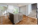 Spacious eat-in kitchen with granite countertops, stainless steel appliances, and hardwood floors at 4205 Woodlawn Dr, Raleigh, NC 27616