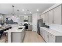 Kitchen with stainless steel appliances, a large quartz island, and ample cabinet space at 429 Providence Springs Ln, Fuquay Varina, NC 27526