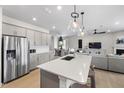 Open-concept kitchen with stainless steel appliances, an island, and a combined dining and living area at 429 Providence Springs Ln, Fuquay Varina, NC 27526