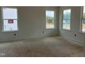 Unfinished room with multiple windows providing ample natural light and views at 4317 Emeline Way # 12, Fuquay Varina, NC 27526