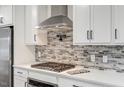 This kitchen boasts stainless appliances, white cabinets, and a stylish backsplash at 4902 Cedar Glen Dr, Durham, NC 27713