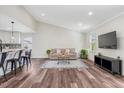 Bright living room features hardwood floors, large windows and plenty of space at 4902 Cedar Glen Dr, Durham, NC 27713