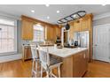 Spacious kitchen with a marble island countertop, stainless steel appliances, and hardwood floors at 5619 Bennettwood Ct, Raleigh, NC 27612
