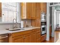 Well-appointed kitchen with stainless steel appliances, custom cabinetry, and a tile backsplash at 5619 Bennettwood Ct, Raleigh, NC 27612