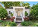 Charming single-story home featuring a covered front porch with beautiful landscaping at 708 Mills St, Raleigh, NC 27608