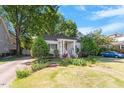 Inviting single-story home with landscaped front yard, driveway, and lush trees at 708 Mills St, Raleigh, NC 27608