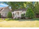 Inviting single-story home with manicured lawn and a quaint, covered front porch at 708 Mills St, Raleigh, NC 27608
