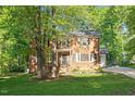 Charming two-story brick home with mature trees and lush green lawn at 7213 St Ledger Dr, Raleigh, NC 27613