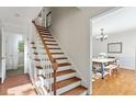 Bright foyer with hardwood staircase leading to dining room with natural light at 7213 St Ledger Dr, Raleigh, NC 27613