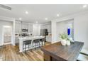 Bright kitchen features a large island, stainless appliances, gray cabinets, and an adjacent dining area with a wooden table at 740 Swim Cave Ln, Wendell, NC 27591
