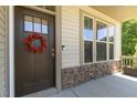 Charming front door with a wreath and stone accents, inviting you into a warm and welcoming home at 7508 Channery Way, Raleigh, NC 27616
