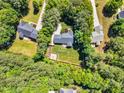 Overhead view of the property showing the home, surrounding trees, and landscape at 76 Bergeson Ct, Fuquay Varina, NC 27526