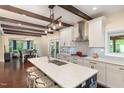 Bright, modern kitchen with island, granite countertops, stainless appliances, and decorative lighting at 7901 Farnham Ct, Raleigh, NC 27615