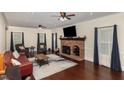 Comfortable living room features a classic brick fireplace, hardwood floors, and ample space at 7901 Farnham Ct, Raleigh, NC 27615