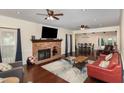 Inviting living room features a classic brick fireplace, hardwood floors, and a cozy seating area at 7901 Farnham Ct, Raleigh, NC 27615