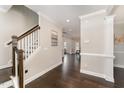 Elegant home foyer featuring hardwood floors, staircase, and crown molding, providing a welcoming entrance at 808 Buckner Ct, Fuquay Varina, NC 27526