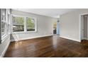 Spacious living room with hardwood floors, large windows offering plenty of natural light, and neutral wall colors at 809 Leon St, Durham, NC 27704