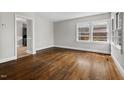 Spacious living room with hardwood floors, large windows offering plenty of natural light, and neutral wall colors at 809 Leon St, Durham, NC 27704