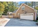 Exterior view featuring a driveway, basketball hoop, and two-car garage at 100 Bradborne Cir, Clayton, NC 27520