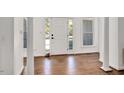 Bright foyer with hardwood floors, white columns, and transom windows at 100 Bradborne Cir, Clayton, NC 27520