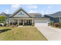Well-maintained home with a two-car garage, covered entry and a beautifully landscaped front yard at 104 Lingonberry Dr, Holly Springs, NC 27540