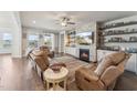 Inviting living room with a cozy fireplace, built-in shelving and lots of natural light at 104 Lingonberry Dr, Holly Springs, NC 27540