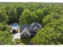 Expansive aerial view of a home surrounded by lush greenery at 10825 Rondeau Woods Ct, Raleigh, NC 27614