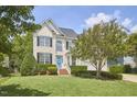 Beautifully landscaped two-story home with a bright blue front door and mature trees at 109 Hogan Glen Ct, Chapel Hill, NC 27516