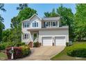 Charming two-story home boasts a landscaped front yard and a convenient two-car garage at 1095 Vauxhall Dr, Apex, NC 27502