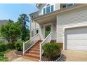 Inviting front porch with brick steps and a bright green front door at 1095 Vauxhall Dr, Apex, NC 27502