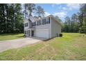 Charming two-story home with a manicured lawn and a two-car garage at 11 Mamie Ferguson Dr, Lillington, NC 27546