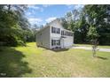 Side view of a charming two-story home with a manicured lawn at 11 Mamie Ferguson Dr, Lillington, NC 27546