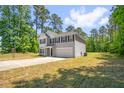 Two-story home featuring green lawn and mature trees in a quiet neighborhood at 11 Mamie Ferguson Dr, Lillington, NC 27546