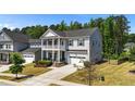 Attractive home with a double porch, complemented by lush landscaping and a well-maintained lawn at 116 Chaseford Ct, Holly Springs, NC 27540