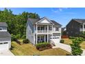 Inviting two-story home with a double porch and manicured landscaping, offering great curb appeal at 116 Chaseford Ct, Holly Springs, NC 27540