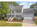 Charming home with a well-maintained lawn, white trim, black shutters, and a two-car attached garage at 116 Dallavia Ct, Morrisville, NC 27560