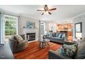 Inviting living room with fireplace, hardwood floors, comfortable seating, and plenty of natural light at 116 Dallavia Ct, Morrisville, NC 27560