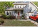 Charming two-story home featuring a red front door, well-manicured lawn, and attached garage with a red sports car at 120 Foley Dr, Garner, NC 27529