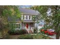 Charming two-story home with gray siding, brick accents, and a well-manicured front yard at 120 Foley Dr, Garner, NC 27529