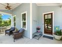 Cozy front porch featuring comfortable seating, stylish decor, and a charming entryway at 120 Mearleaf Pl, Holly Springs, NC 27540