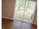 Bright living room with sliding glass doors leading to outdoor area with vinyl floors at 1222 Teakwood Pl, Raleigh, NC 27606