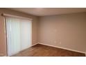 Bright living room with sliding glass doors and window blinds and vinyl floors at 1222 Teakwood Pl, Raleigh, NC 27606