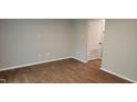 Clean and bright living room with vinyl floors next to a door to a storage area at 1222 Teakwood Pl, Raleigh, NC 27606