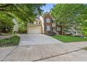 Inviting two-story home with a combination brick and siding exterior, showcasing a well-maintained front yard at 13017 Townfield Dr, Raleigh, NC 27614