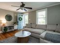 Comfortable living room with hardwood floors, a blue front door, and a stylish sectional sofa at 1510 Hanover St, Raleigh, NC 27608