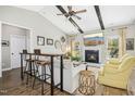 Cozy living room with vaulted ceiling, wooden beams, fireplace and comfortable seating at 17 Kaki Ct, Selma, NC 27576