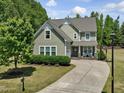 Beautiful two-story home with an attached garage, lush landscaping, and a well-manicured lawn at 1701 Bodwin Ln, Apex, NC 27502